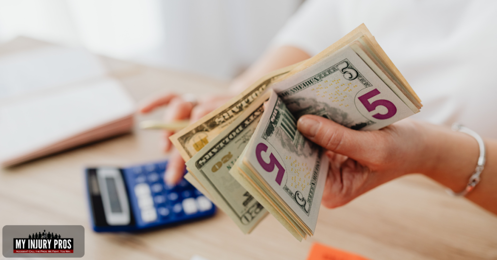 Medical bills, money, and a calculator illustrating What Can You Sue For In A Personal Injury Case.