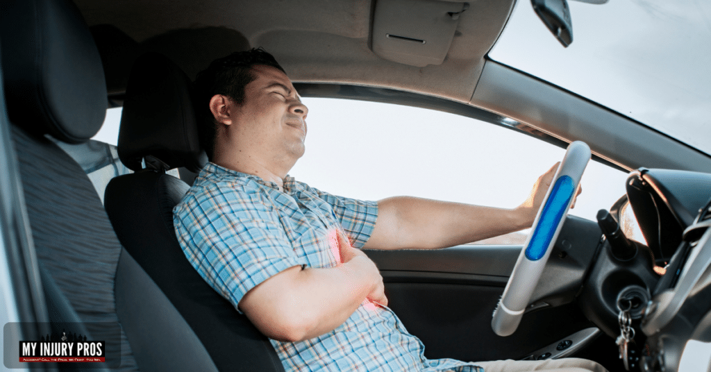 sternum pain after car accident driver holding chest from seatbelt injury